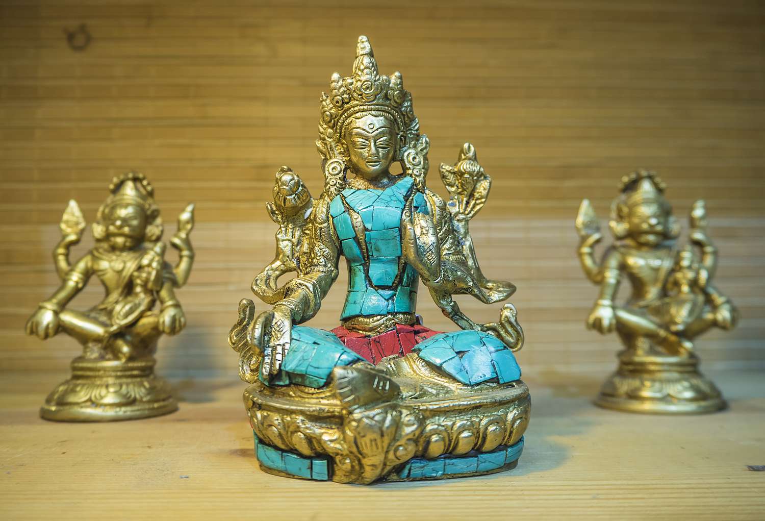 Tibetan brass and stone statue of Green Tara close-up